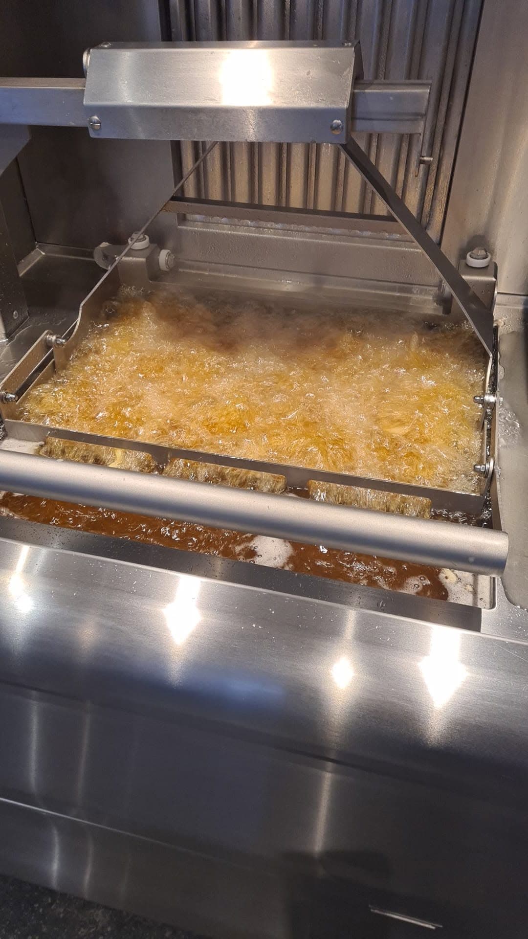 Frieten in de frituurinstallatie van Frituur Wendy